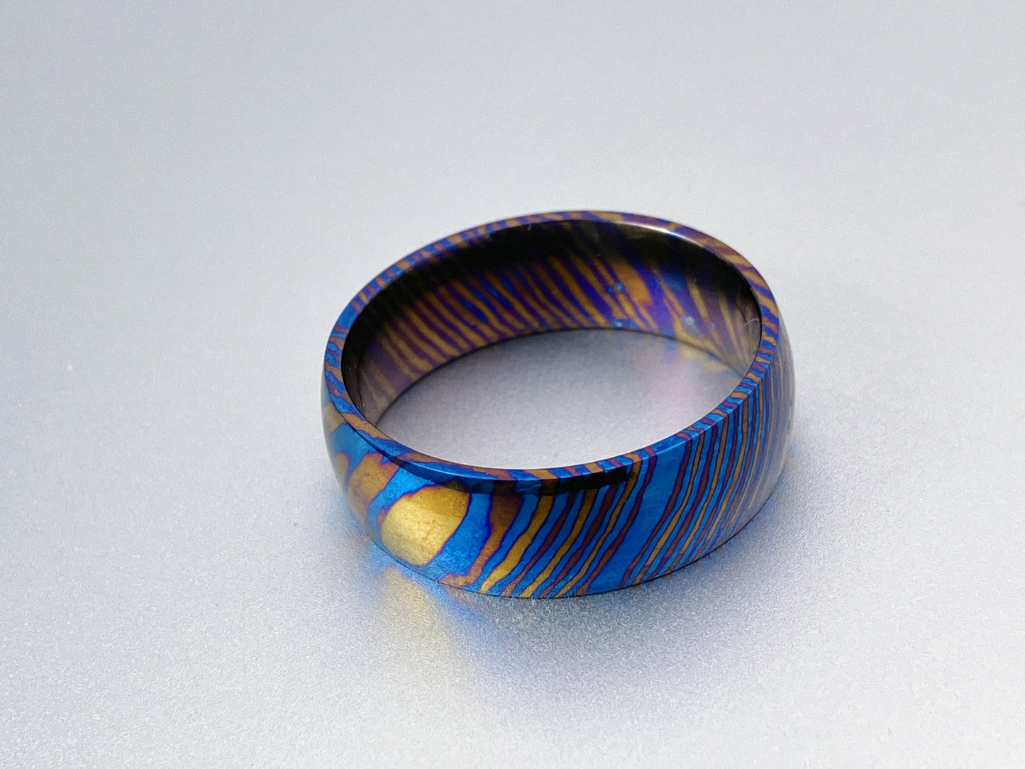 Classic Mokume Ti (Damascus Titanium) ring, three alloys twisted pattern, dome and polish